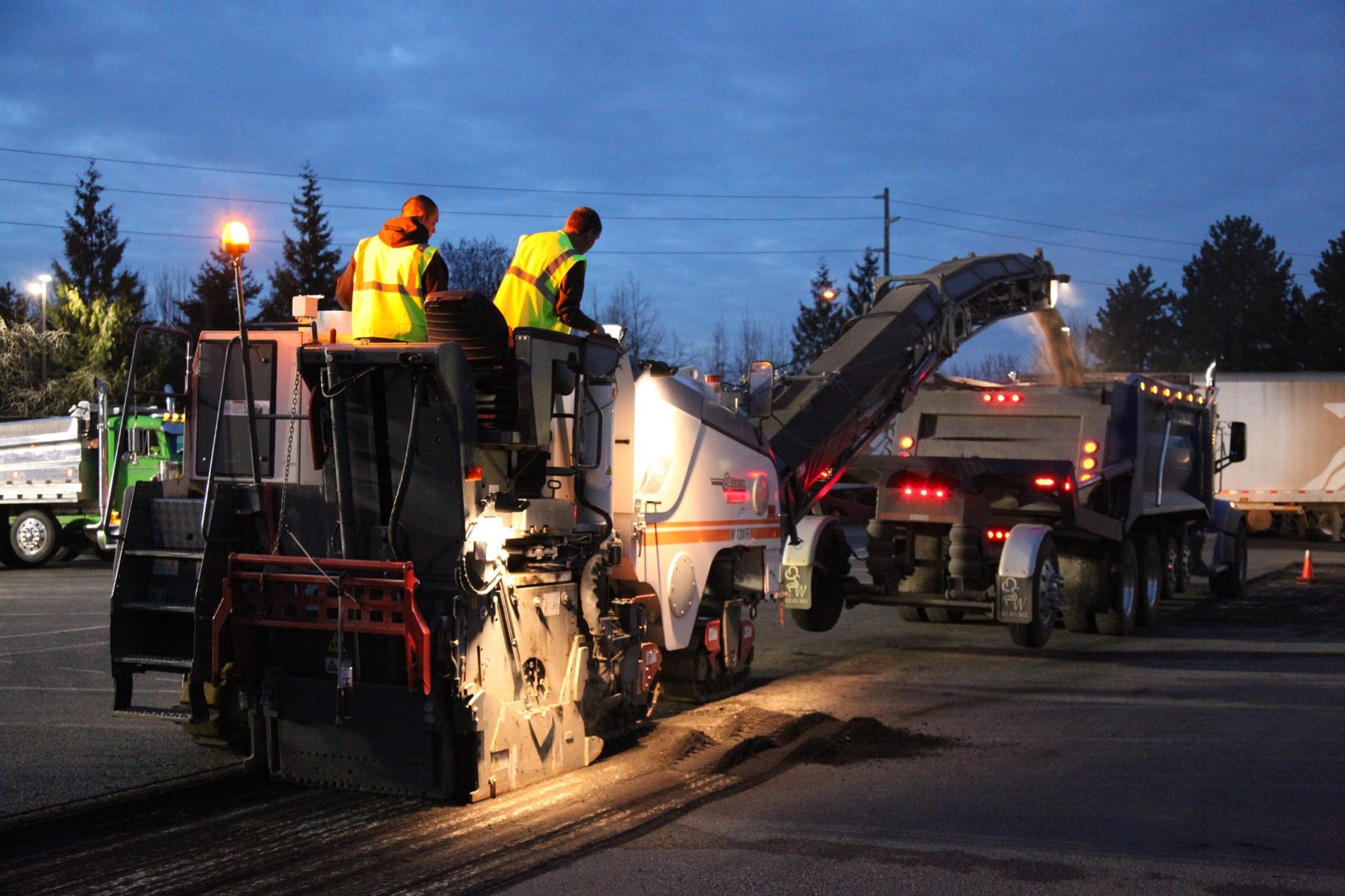 Asphalt grinding machine at dawn removing old pavement, AC Moate Industries